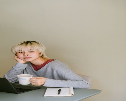 A woman taking a break, looking away from her computer screen