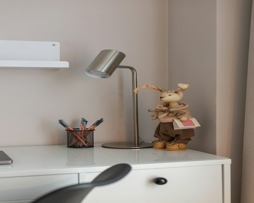 A well lit desk corner with a notepad and a pen ready for editorial work