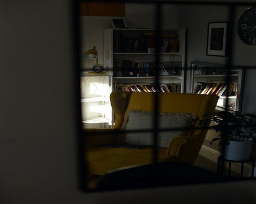 Sunlight streaming through a window onto a comfortable reading chair