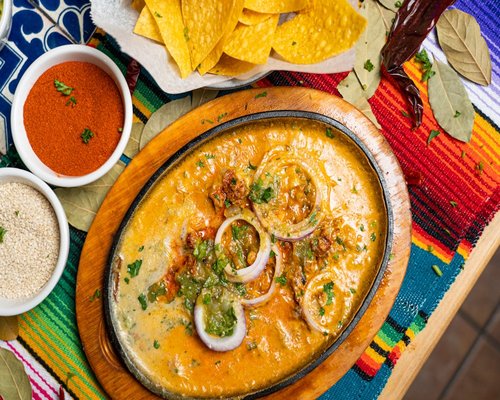 A colorful plate of traditional homemade Mexican food with fresh vegetables